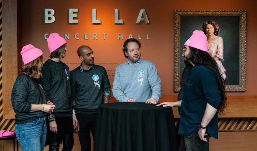 Brad Mahon speaking with his team in the lobby of the Bella Concert Hall.